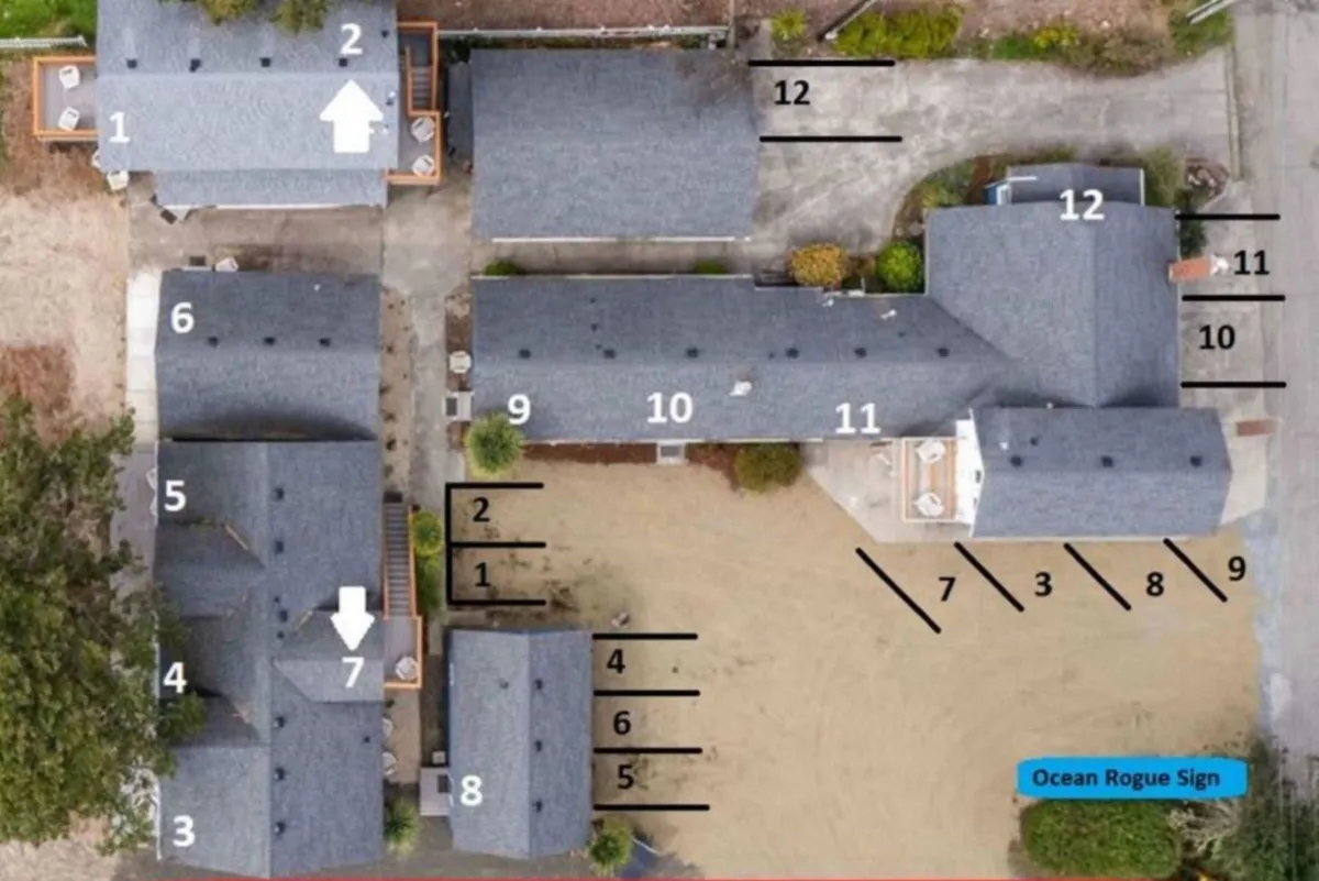 Multiple buildings are arranged around an open landscaped space with the Ocean Rogue sign, emphasizing areas designed for group activities and outdoor relaxation.